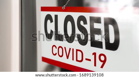 Closed businesses for COVID-19 pandemic outbreak, closure sign on retail store window banner background. Government shutdown of restaurants, shopping stores, non essential services. Royalty-Free Stock Photo #1689139108