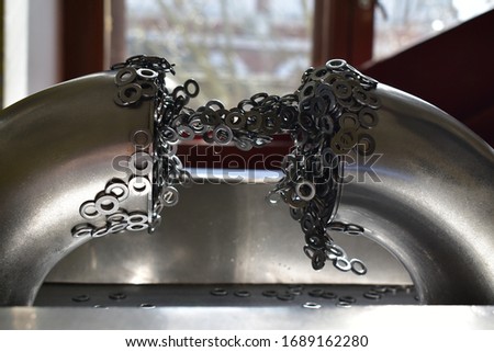 Ferromagnet rings magnetized to the metal rack Royalty-Free Stock Photo #1689162280