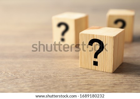 Cube with question mark on wooden background. Space for text Royalty-Free Stock Photo #1689180232