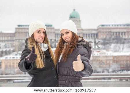 Two Women playing with Snow on Winter