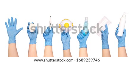 Health protection equipment such as gloves, masks and sanitizers held in hands, isolated on white background Royalty-Free Stock Photo #1689239746