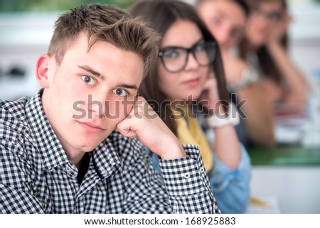 Portrait of a highschool boy posing in classroom