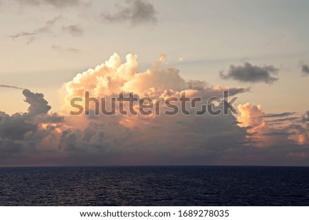 View of the sunset from the ship underway and in the port. Colorful views of the surface of the water and the sky with clouds.