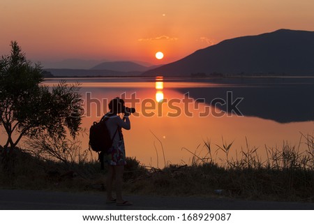 Photographer shooting on sunrise on lake