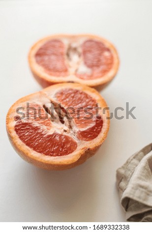 cut grapefruit in half on a white background