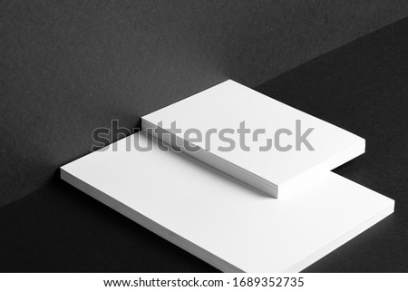 Stacked white businesscards for branding identity on black background, copy space