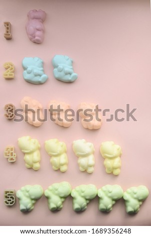 Children's educational game. Jelly hippo sweets background Flat lay photo