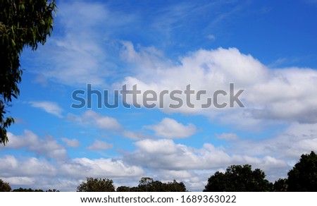 A bright vivid blue sky with clouds on a sunny morning.