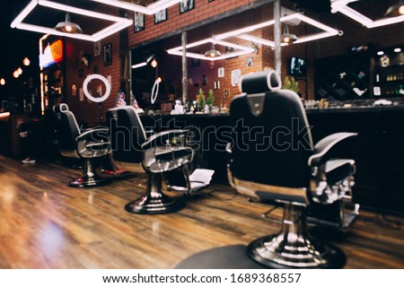 modern empty barbershop interior with chairs, mirrors and lamps Royalty-Free Stock Photo #1689368557