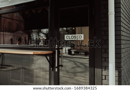 "Closed" message board on a cafe doors window. Economic crisis