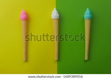 Top view of an ice cream pen on two color background which are green and yellow.