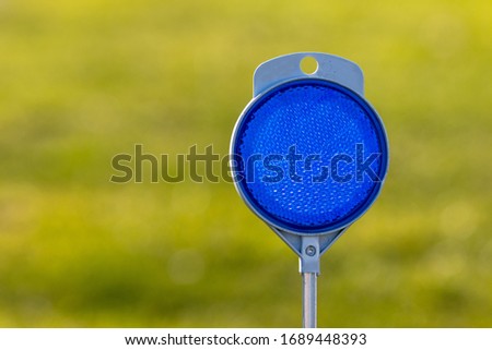 Blue light reflector in green background