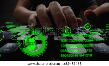 Man working on laptop computer keyboard with graphic user interface GUI hologram showing concepts of big data science technology, digital network connection and computer programming algorithm.