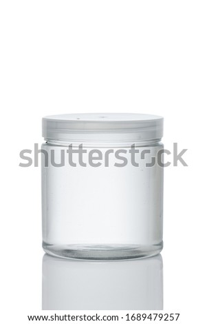 Clear lotion container. Empty plastic cosmetic jar with transparent lid, high angle and reflection for mockup design isolated on white background Royalty-Free Stock Photo #1689479257
