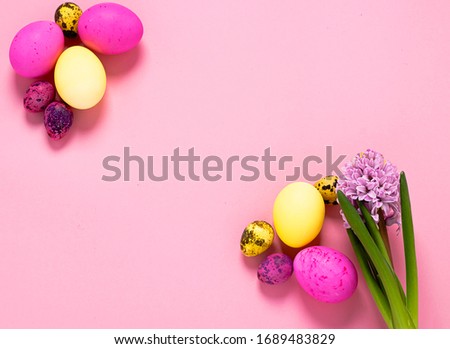 Happy easter concept. Colored eggs on a pink background. Copy space flat layout. Banner with place for advertising.