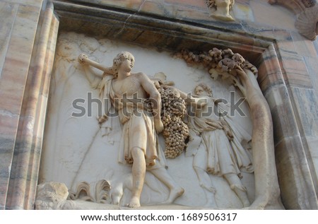 Depiction of Israelites carrying grapes of Canaan on the exterior of the Duomo di Milano in MIlan, Italy Royalty-Free Stock Photo #1689506317