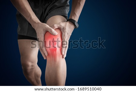 Joint pain, Arthritis and tendon problems. a man touching nee at pain point Royalty-Free Stock Photo #1689510040