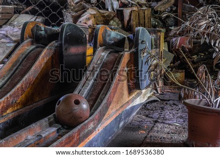 Ball on a bowling alley of an abandoned inn with lots of objects