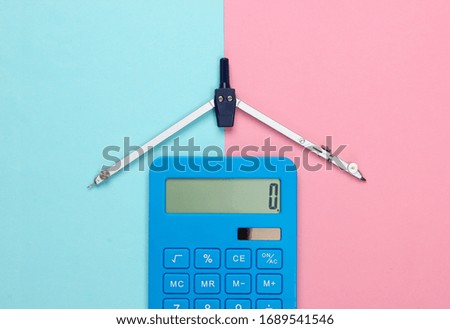 Calculator and compass on pink blue pastel background. Top view