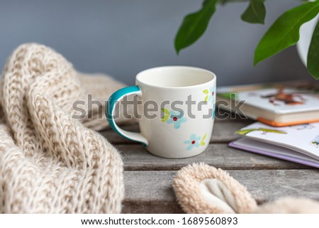Kid's cup stands on a wooden table. Childhood Royalty-Free Stock Photo #1689560893