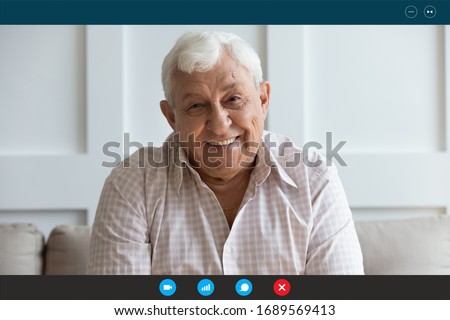Headshot portrait screen view of smiling senior grandfather talk on video call on laptop with relatives or kids, happy elderly man speak have pleasant online Webcam conversation on computer at home Royalty-Free Stock Photo #1689569413