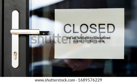 Business owner hangs on door announcement of closure due to coronavirus quarantine. Royalty-Free Stock Photo #1689576229
