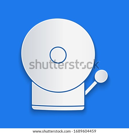Paper cut Ringing alarm bell icon isolated on blue background. Fire alarm system. Service bell, handbell sign, notification symbol. Paper art style. Vector Illustration