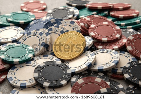 Gold Bitcoin Thrown on Casino Chip Royalty-Free Stock Photo #1689608161