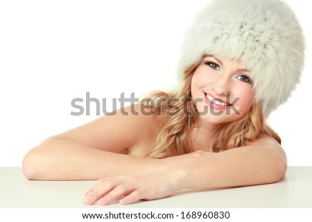 Beauty fashion model girl in a fur hat.Isolated on white background
