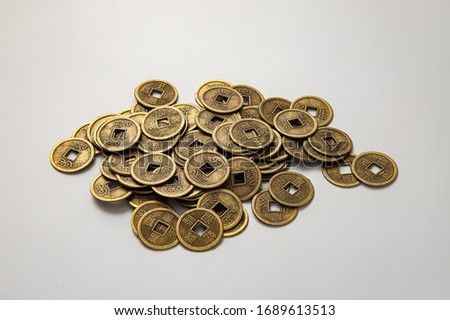 Oriental old coins stacked on the floor Royalty-Free Stock Photo #1689613513