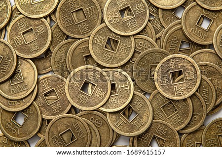 Close-up of oriental old coins lying on the floor Royalty-Free Stock Photo #1689615157