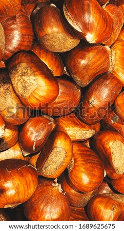 Ripe chestnuts close up, top view. Food background. Raw Chestnuts