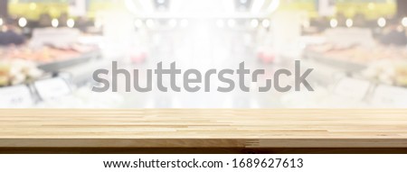 Wood table top in supermarket banner background  for display or montage your products