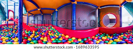 children's playroom with colorful balls and a slide made of plastic. . Cylindrical panorama 360 Royalty-Free Stock Photo #1689633595
