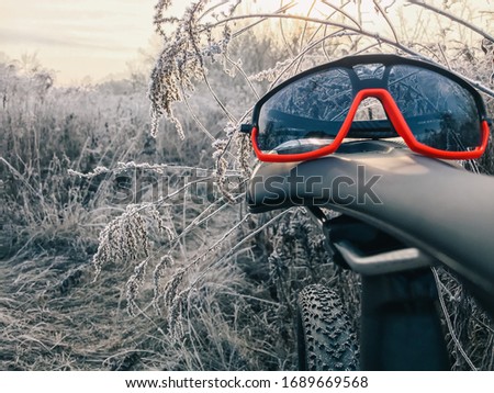Mountain bike glasses on the trail against colorful sunset