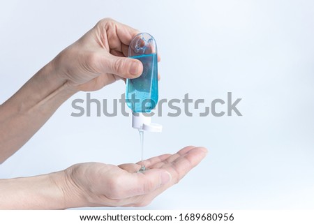 People using bottle of alcohol gel clean hands hygiene prevention of coronavirus virus outbreak.