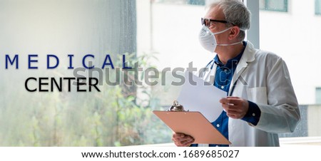 doctor in hospital with mask and reports, medical center concept