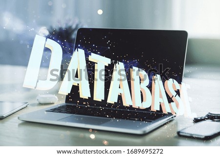 Double exposure of creative Database word hologram on laptop background, research and development concept