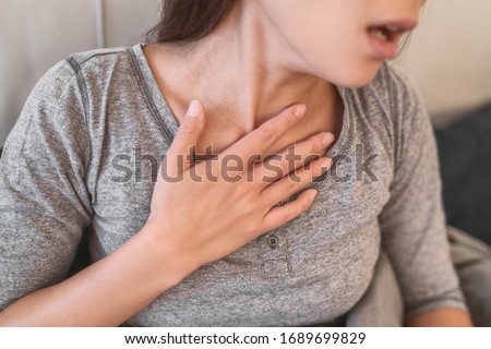 COVID-19 shortness of breath pneumonia woman with Corona virus symptoms such as, fever, body aches breathing difficulties. Royalty-Free Stock Photo #1689699829