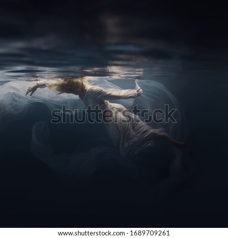 Woman in a sequin dress underwater