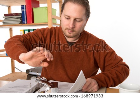 man with hole puncher in the office