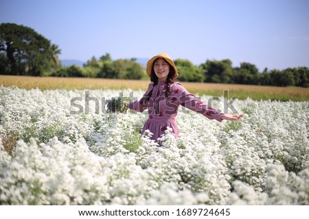 Woman holding flowers in Cutter flower fields at Mae Rim district, Chiang Mai, Thailand.
