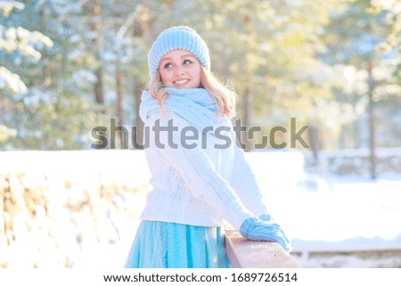 Beautiful girl walks in the winter on the nature of the snow smiling forest sun bright picture girl enjoys the winter frosty day
