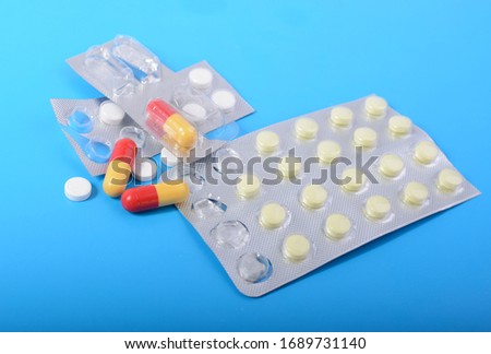tablets in a blister pack, and in different colors, antibiotics in the concept of health care are different