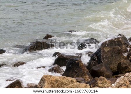 Sea, rocks, waves lapping the rocks