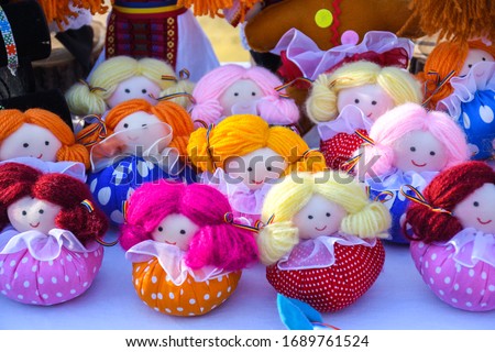 Stuffed dolls dressed in traditional Romanian clothing. Beautiful handmade handicraft, artisanal decorative gift or souvenir for friendsand kids, children