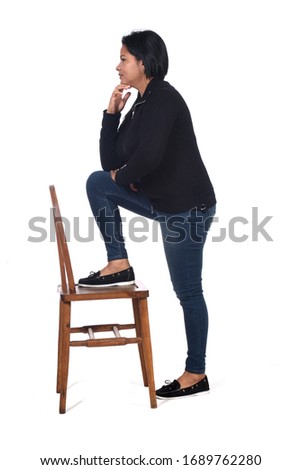 woman playing with a chair in white background,profile hands on chin
