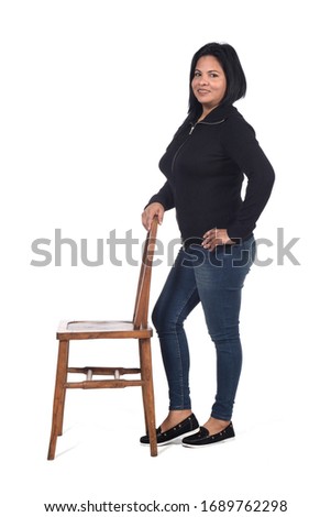 woman playing with a chair in white background