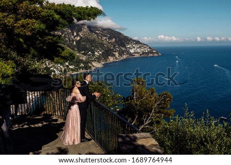 Amazing couple in love are looking to the sea view 