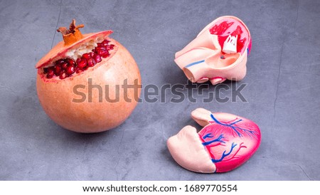 red juicy pomegranate and heart shape, healthy food